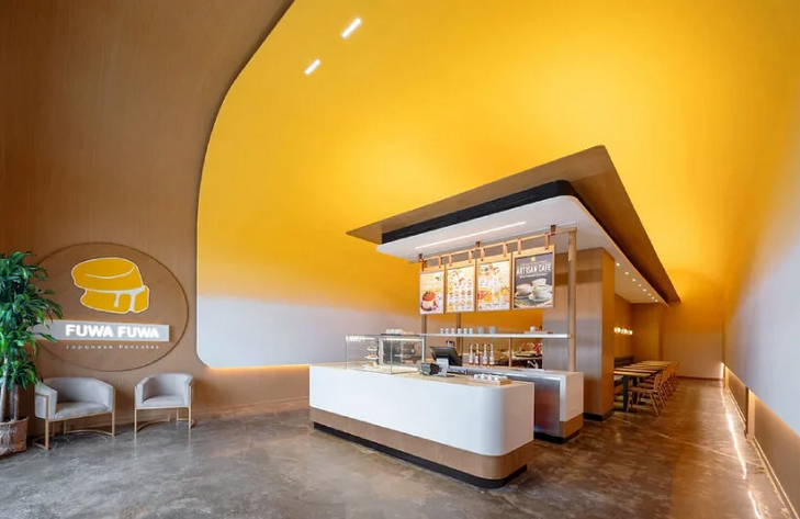 cave café in canada shines like the sun with yolk yellow interior