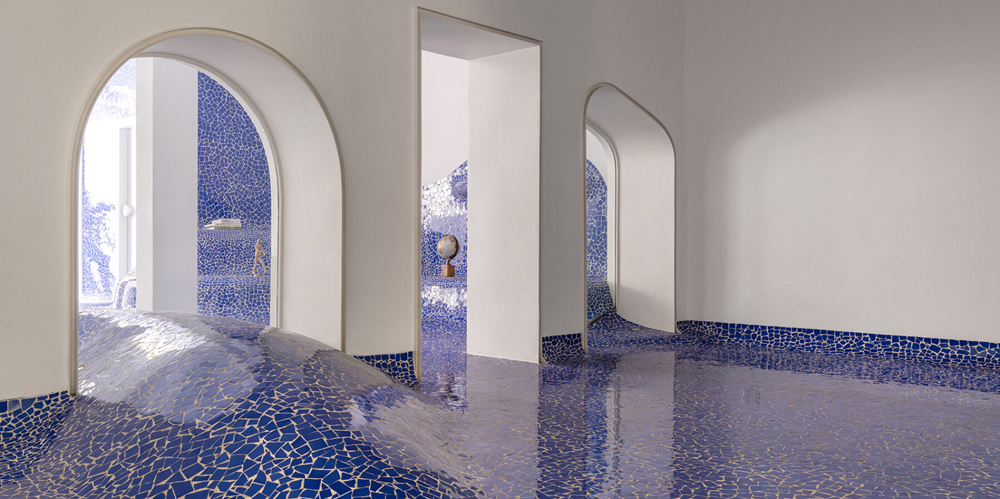 abin design studio sculpts its art rickshaw gallery with "islands" of undulating blue tilework