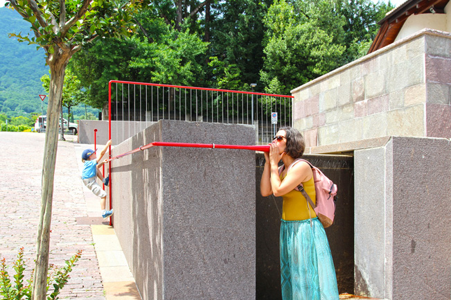 Playful red tubes form moradavag`s interactive sound installation at italian fire station