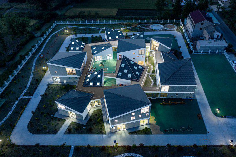 kindergarten in rural china organized as a mini village of scattered volumes