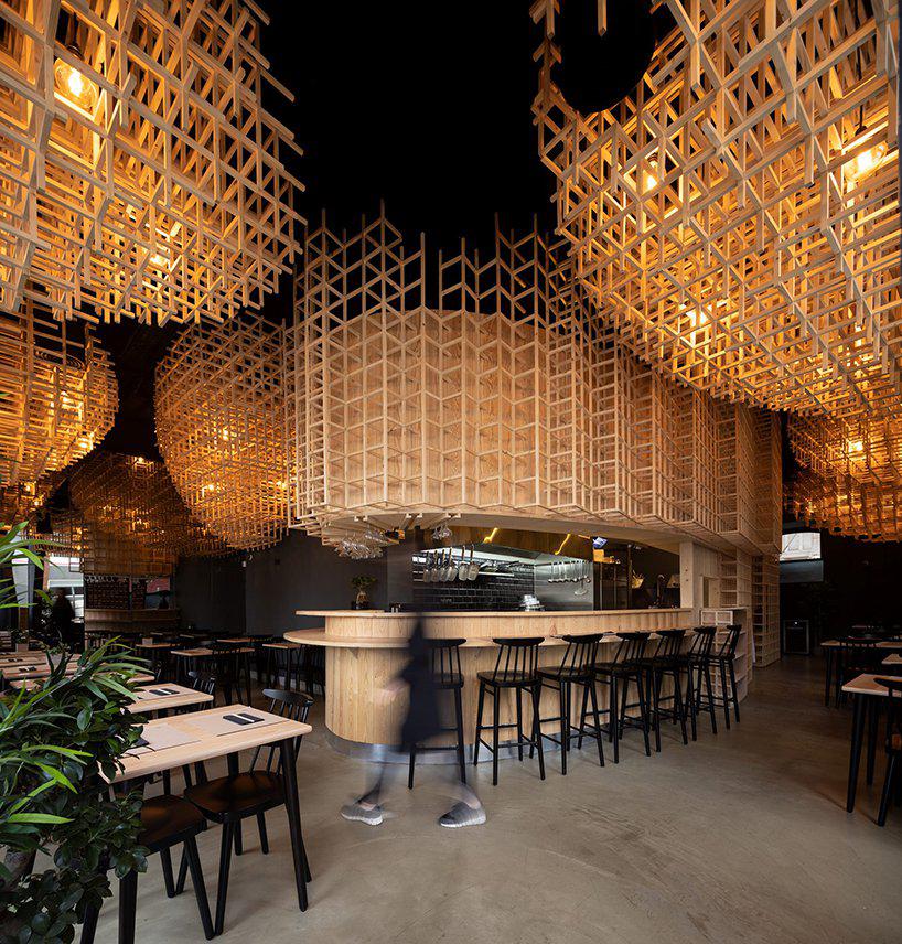 JCFS architects suspends wooden trellises inside lisbons ajitama ramen bistro