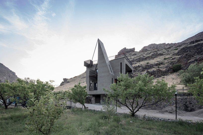 gray villa by white cube atelier draws from irans irregular rocks + mountains