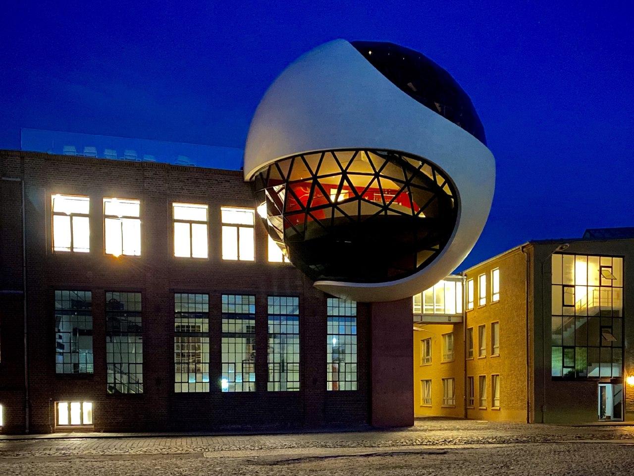 An Oscar Niemeyer-Designed White Concrete and Glazed Sphere, Generates Extension for a Factory Canteen in Germany